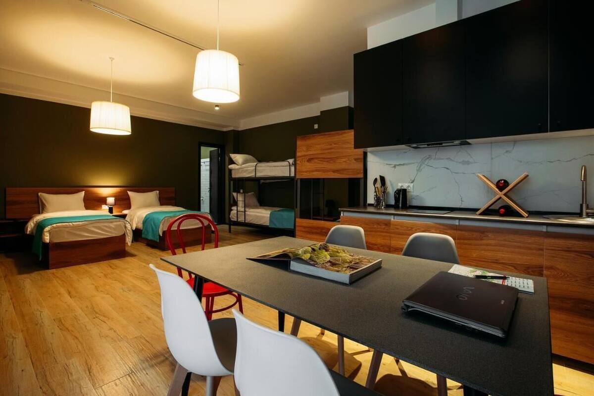 Family Studio, Balcony, Garden View | Living area | 35-inch Smart TV with cable channels