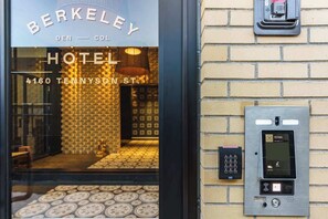 Experience the Berkeley Hotel's modern exterior, featuring a brick facade and sleek metal panel.