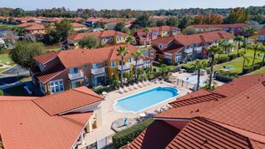 A residential area with multiple houses, a swimming pool, and a tennis court.