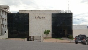 A hotel named ASA BRANCA with a modern facade, a small tree in front, and a parked truck. - HOTEL ASA BRANCA (Seabra)
