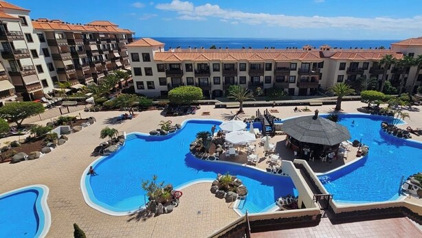 A resort with multiple swimming pools, a beach area, and a view of the ocean. - Boutique one bed sea views free wifi (Arona)