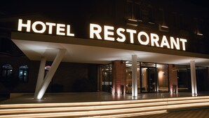 A hotel entrance with a sign reading "HOTEL RESTORANT" and steps leading up to the entrance. - Hotel Albulena (Mamurras)