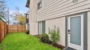 A residential building with a front door, a small front yard, and a wooden fence. - 2 Bed/1 Bath in NE - Close to Mississippi Ave (Portland)
