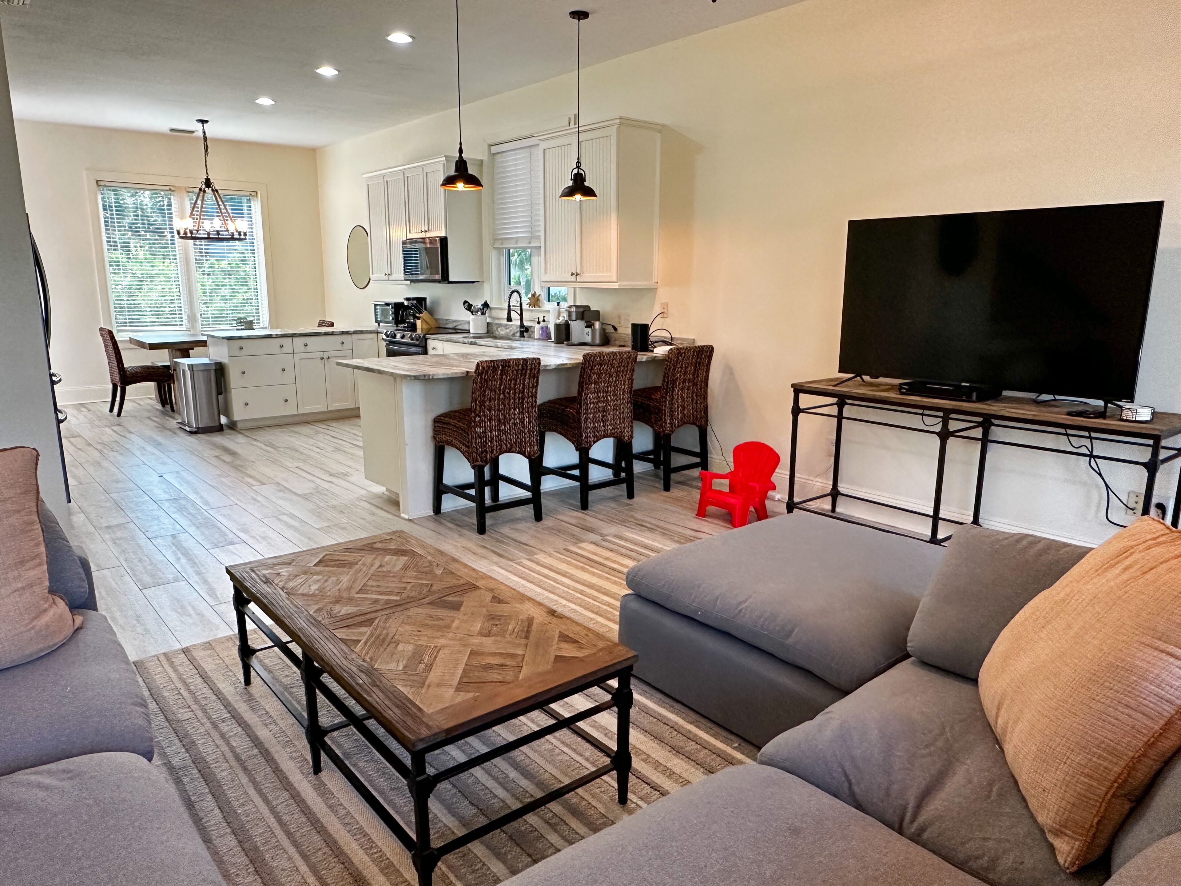 A modern living room with a sofa, a coffee table, and a TV.