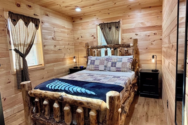 Enjoy this beautiful queen size log bed, while relaxing in the cozy bedroom.