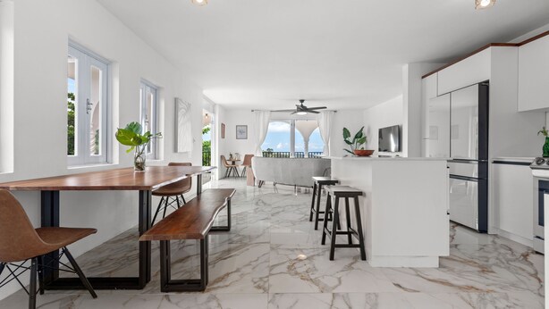 A spacious kitchen with marble flooring, white cabinetry, and a large island. - Nice Pool w Breathtaking Mountain Views BBQ (Carolina)