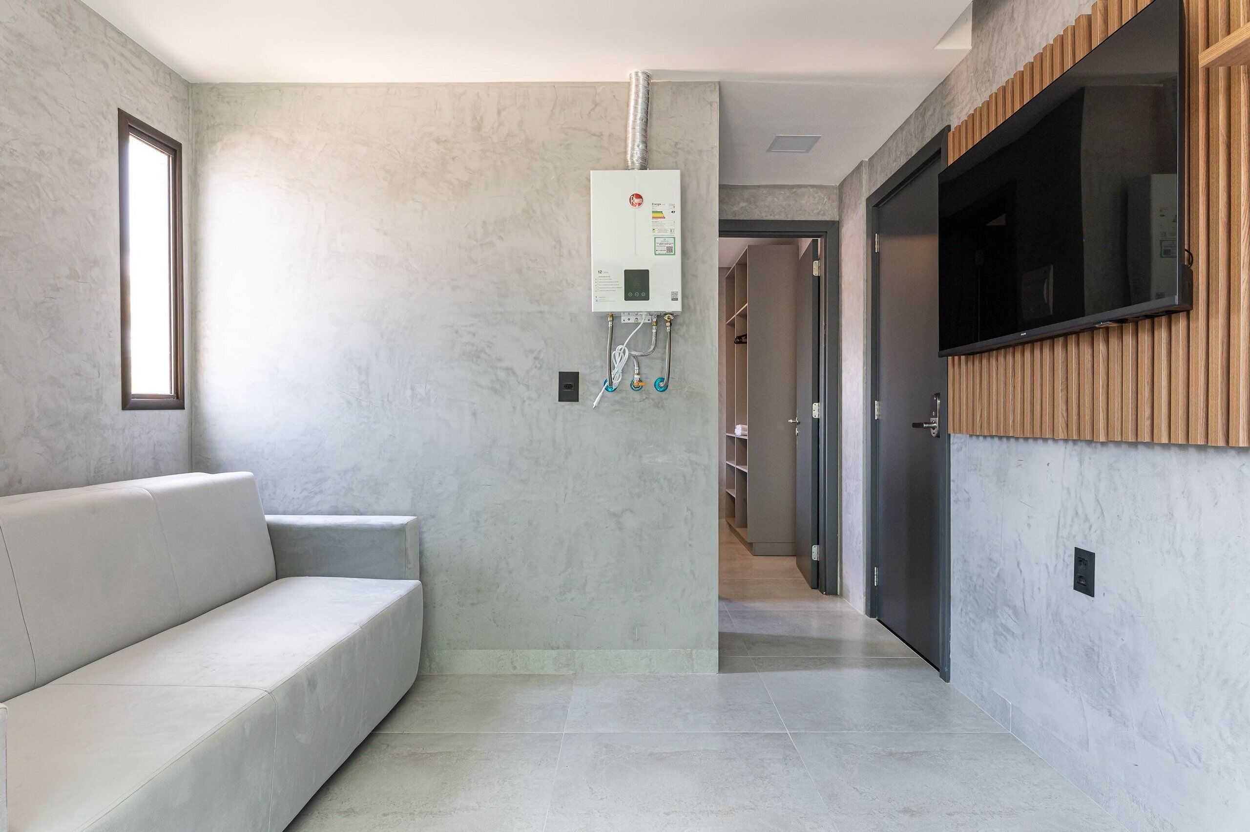 A modern interior with a built-in heater, a flat-screen TV, and a minimalist design.