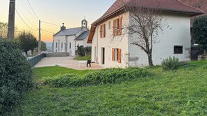 Ein traditionelles Gebäude mit rotem Ziegeldach, weißer Fassade und einem kleinen Glockenturm.