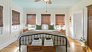 A bedroom with a bed, a ceiling fan, and a window with blinds. - Your Ultimate Coastal Retreat! 5 bedroom, 4 bathroom home in Murrells Inlet, SC! (Murrells Inlet)