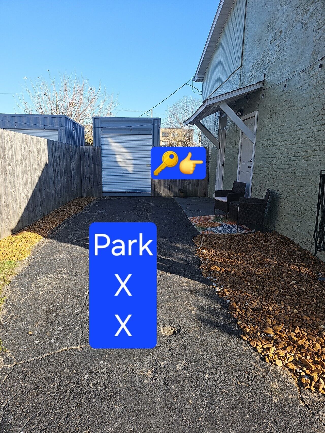 A parking area with a blue sign indicating a parking spot marked 'Park X'.