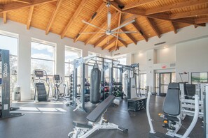 A gym with various exercise equipment, large windows, and a wooden ceiling. - Near Westin | Top Floor | Hot Tub | Workspace (Scottsdale)