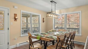 A dining area with a large wooden table set for six, surrounded by rustic chairs. - Stephen Way by Avantstay Hot Tub + Game Room Albrightsville (Albrightsville)