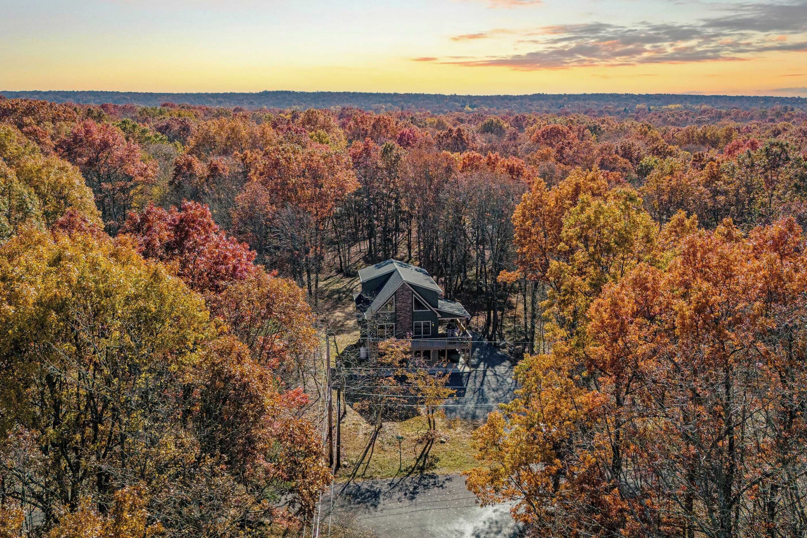 A house surrounded by autumn foliage.