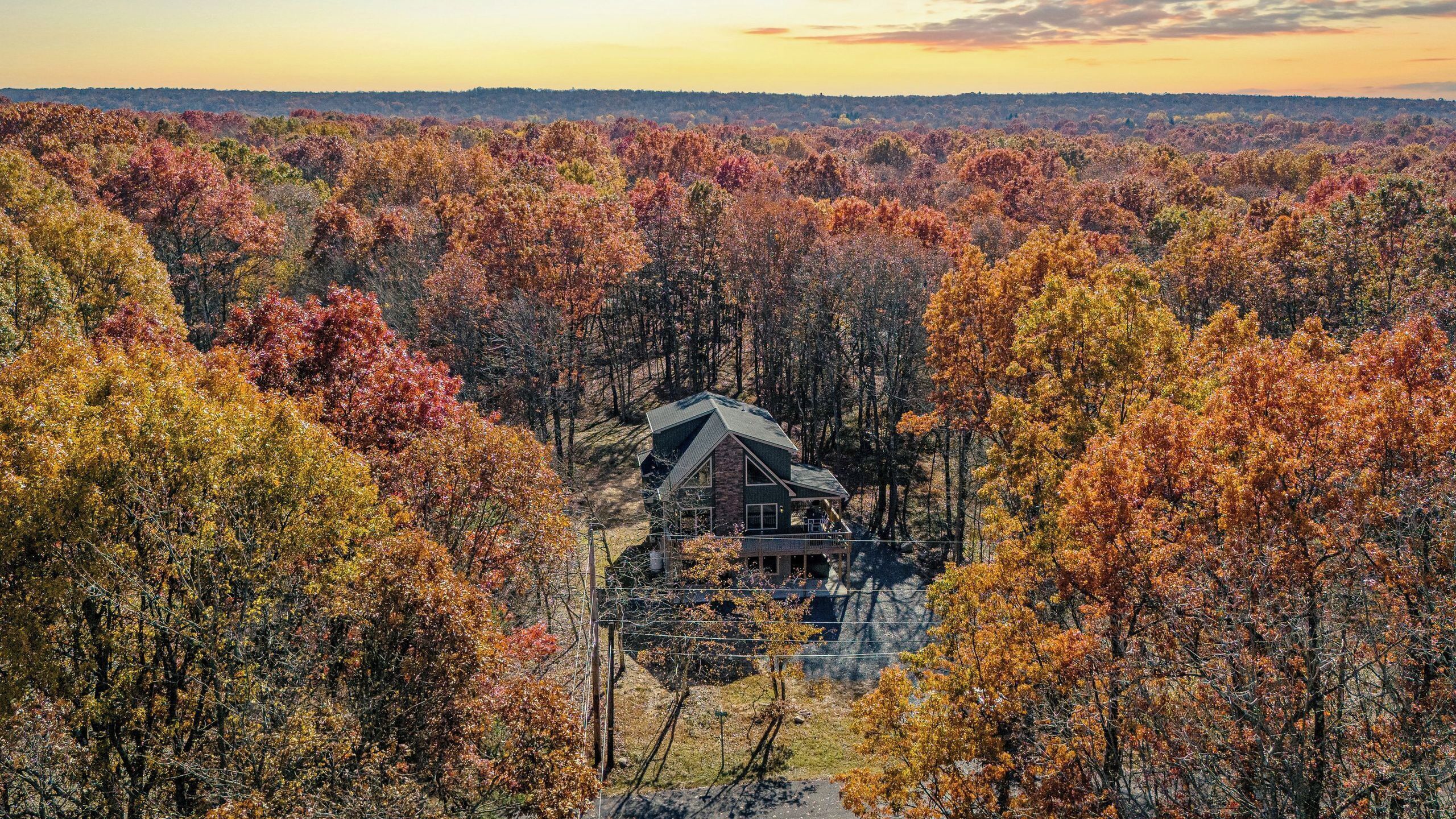 A cabin surrounded by autumn foliage.