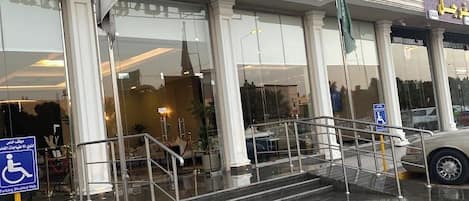 A hotel entrance with a sign reading "Gold Inn & Suites".