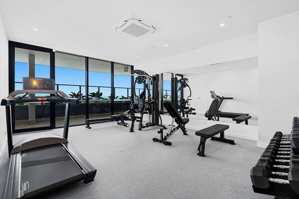 A modern gym with treadmills, weight machines, and benches. - TRYP by Wyndham Southport Gold Coast (Southport)
