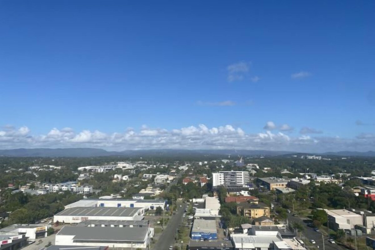 A cityscape with buildings, roads, and a clear sky.