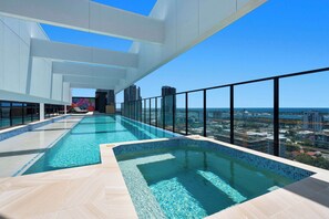 A rooftop infinity pool with a city view, large windows, and a modern architectural design. - TRYP by Wyndham Southport Gold Coast (Southport)