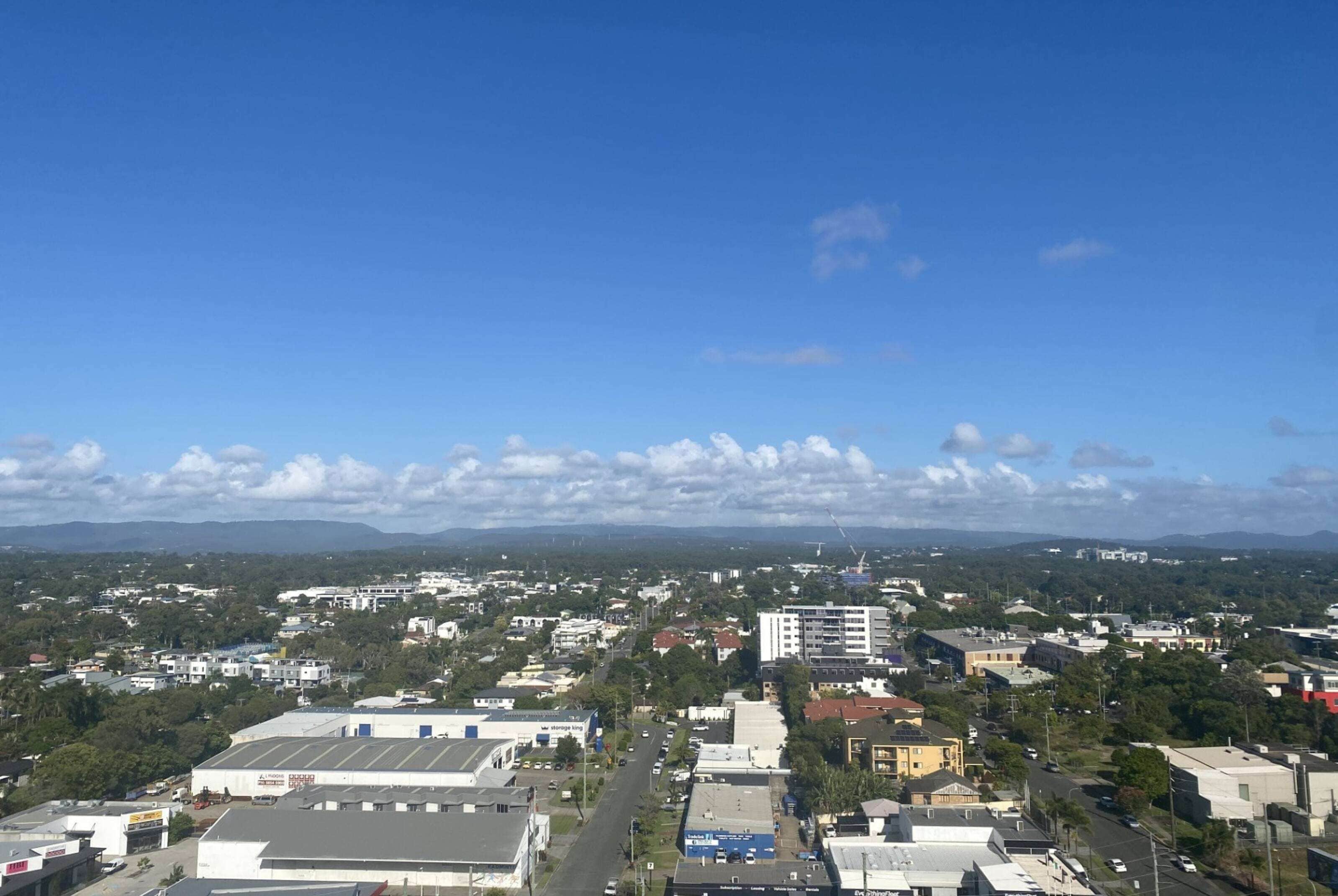 A cityscape with buildings, roads, and a clear sky.
