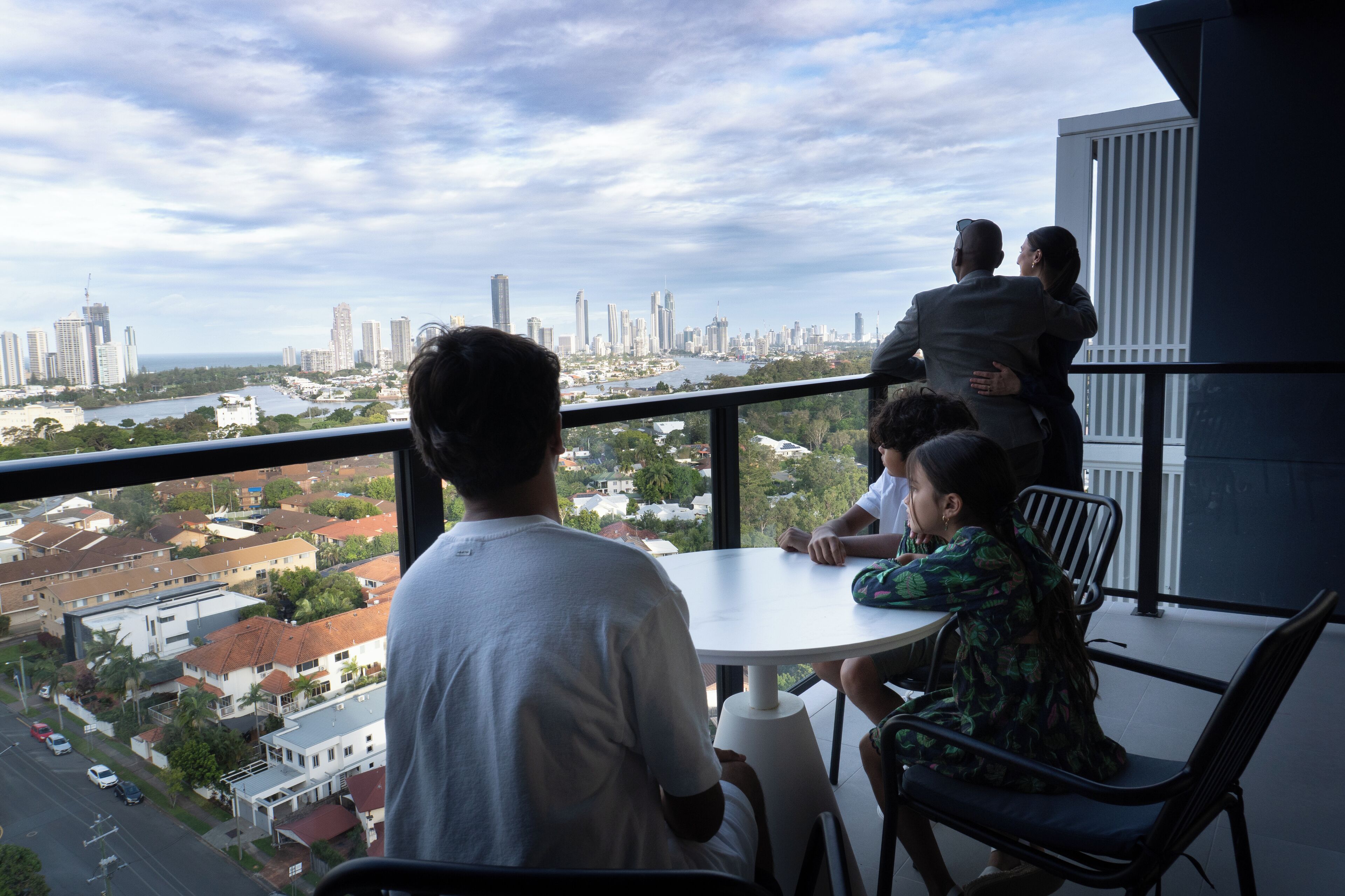 A balcony with a city view, a round table, and chairs.