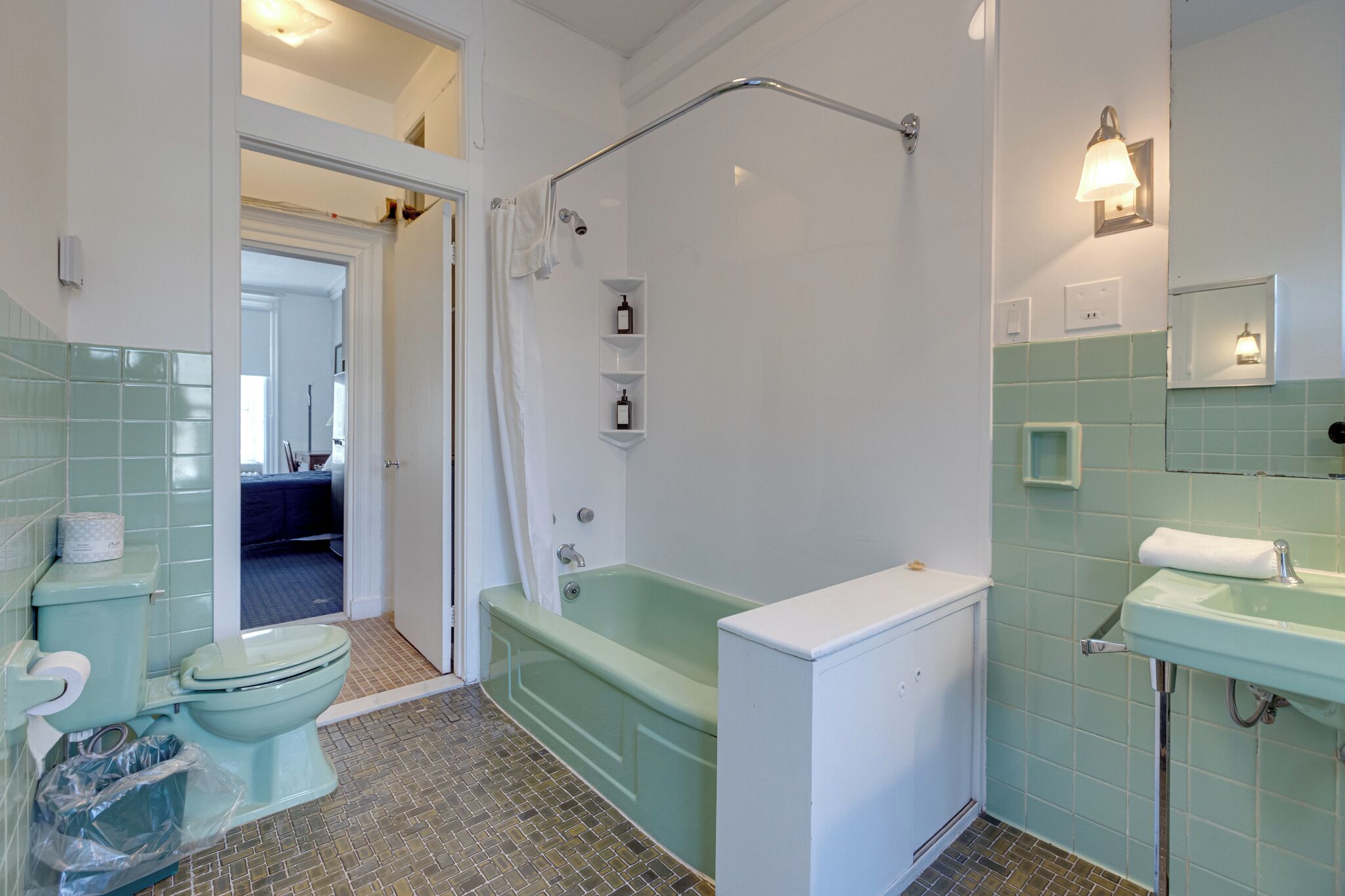 A bathroom with a toilet, bathtub, and sink.