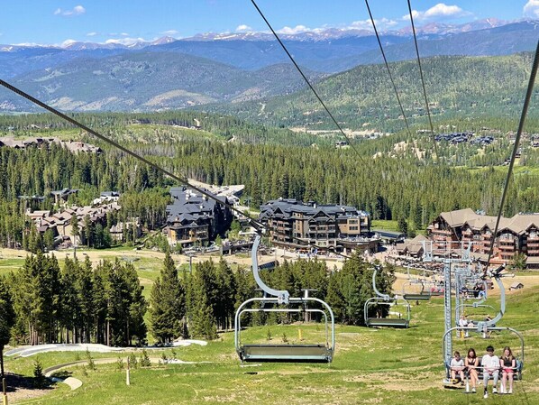 A ski resort with cable lifts, lodges, and a mountainous backdrop.