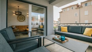 A modern living room with a sofa, chairs, a coffee table, and a dining table. - Spacious Luxury Trogir Apartments - Comfort Two Bedroom Apartment (Trogir)