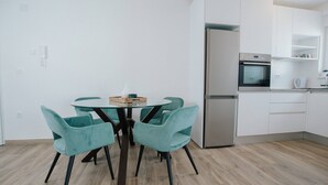 A modern kitchen with white cabinets, a stainless steel refrigerator, and a built-in oven. - Spacious Luxury Trogir Apartments - Standard Two Bedroom Apartment (Trogir)