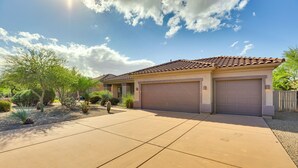 A residential house with a tiled roof, two garage doors, and a paved driveway. - Golfer's Retreat w/ Outdoor Oasis in Scottsdale! (Scottsdale)