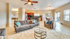 A spacious living room with a grey sofa, a white shag rug, and a glass coffee table. - Golfer's Retreat w/ Outdoor Oasis in Scottsdale! (Scottsdale)