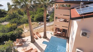 A hotel with a rooftop pool, solar panels, and a view of the sea. - Holiday Home Boni - Holiday Home (Rab)