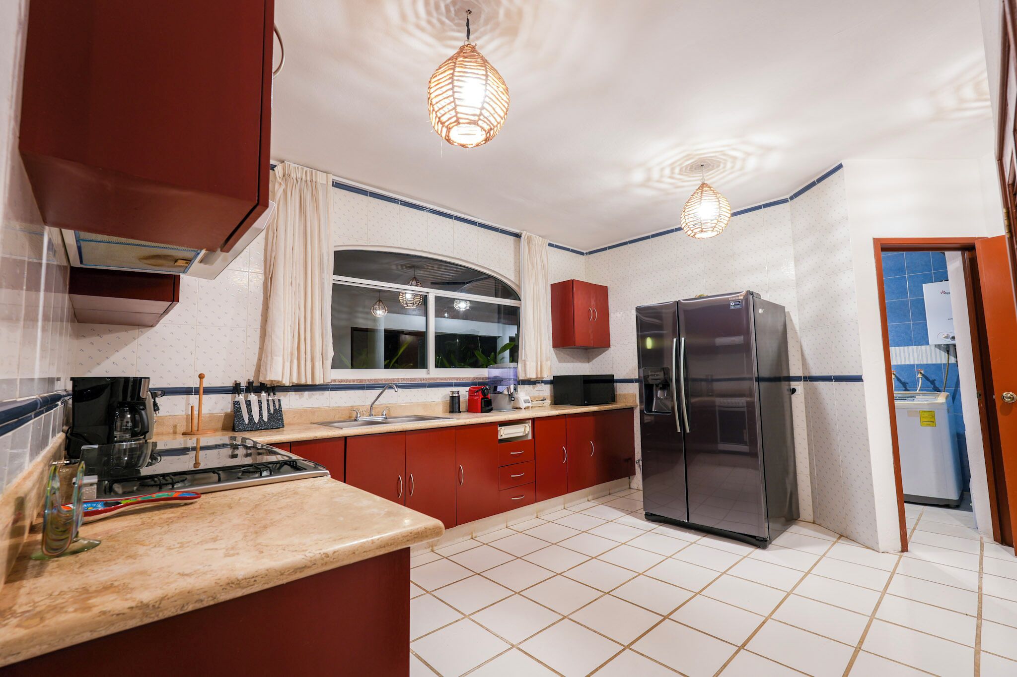 Una cocina con estufa, refrigerador y armarios.