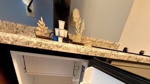 An open refrigerator with two shelves and a freezer compartment.