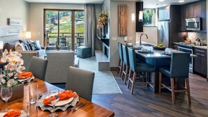 Habitación de hotel moderna con comedor, cocina y balcón con vistas al exterior.