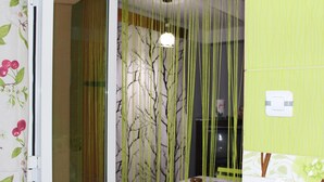 A bathroom with a green wall, a white door, and a window with a curtain. - Relaxing getaway, Studio between Béjaïa and JIJEL (Ziama Mansouriah)