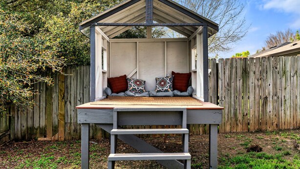 A wooden deck with a bench and a small shelter. - Solace in South Austin - Game Room (Austin)