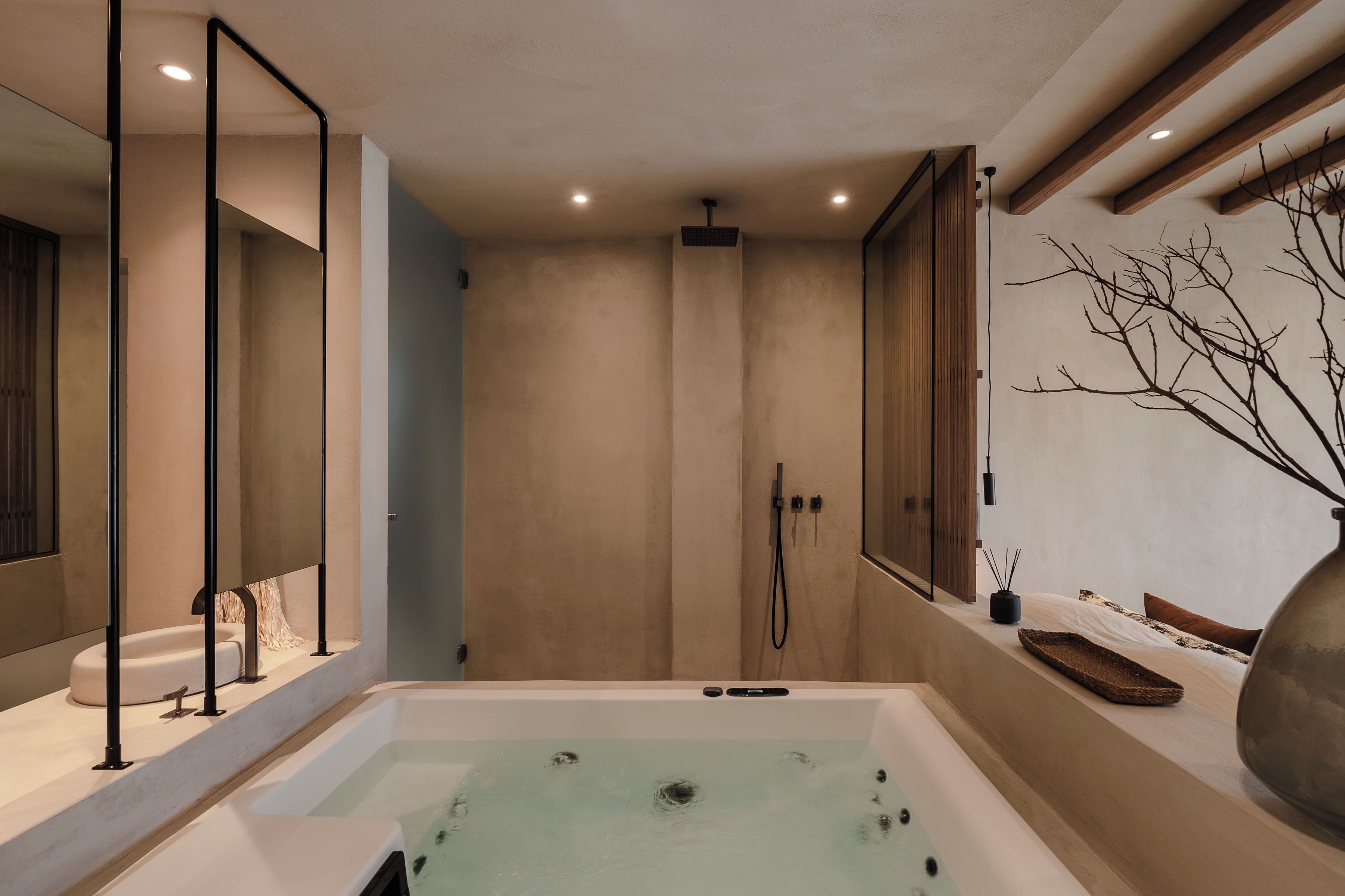 A modern bathroom with a large bathtub, a shower, and a vanity area.