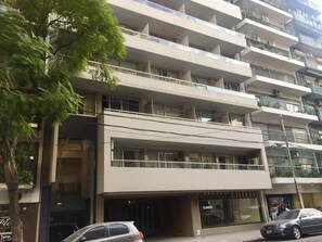 Stylish residential building with modern design, large windows, and balconies.