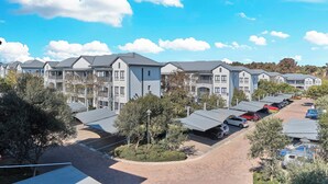 A residential building complex with multiple two-story houses, a parking area, and a landscaped garden. - Luxury & Secure apartment - Fourways (Fourways)