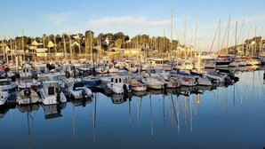A marina with numerous boats docked, surrounded by residential buildings. - House Six - PLENEUF VAL ANDRE (PLENEUF VAL ANDRE)