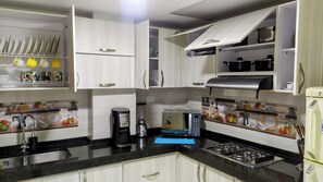 Microwave, coffee/tea maker, cookware/dishes/utensils, spices