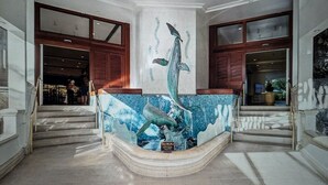 A lobby with a large mural of a whale and a staircase. - Waikiki ocean view studio, easy walk to beach, shopping, restaurants (Honolulu)