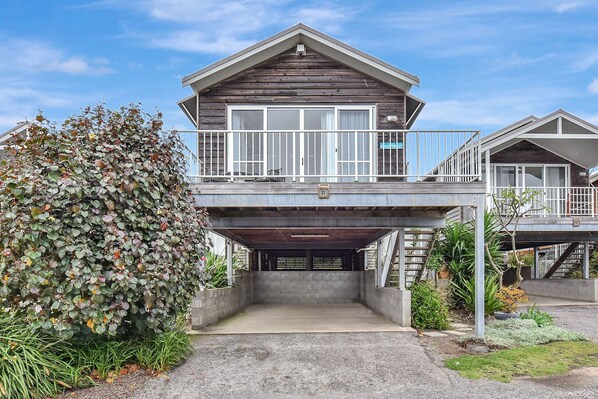 A two-story building with a covered driveway and a balcony. - Ahoy Villa at Caves Beach Villas (Caves Beach)