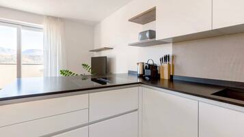 Fridge, stovetop, dishwasher, coffee/tea maker