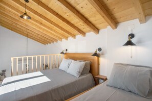 A bedroom with a wooden ceiling, a bed with a headboard, bedside tables, and wall-mounted lamps. - 'Casa Valada My Land' with Shared Pool, Wi-Fi and Air Conditioning (Valada)
