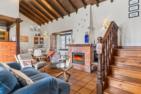 TV, fireplace. Rural House 'El Llagar De Naveda' with Mountain Views, Private Terrace & Wi-Fi