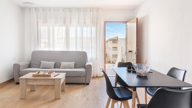 A modern living room with a sofa, coffee table, and dining area with chairs and a table. - Apartment 'Arena De 2 Mares' with Sea View, Shared Pool and Private Terrace (La Manga)