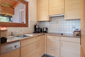 Fridge, stovetop, dishwasher, coffee/tea maker