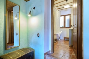A bathroom with a bathtub, a sink, and a mirror.