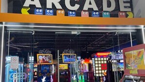 An arcade with various gaming machines and a sign that reads "ARCADE".